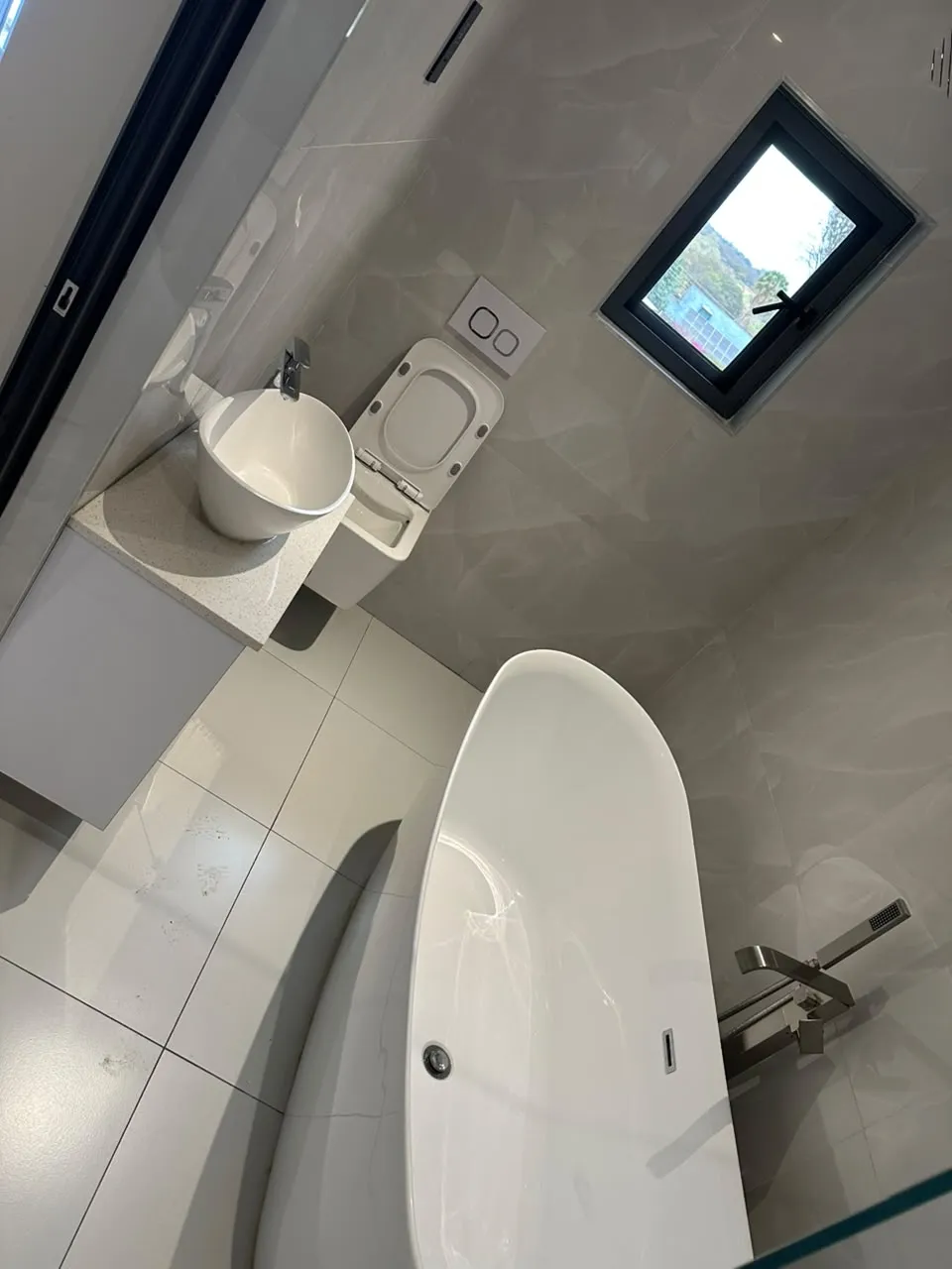Finished bathroom with freestanding bath, basin and toilet