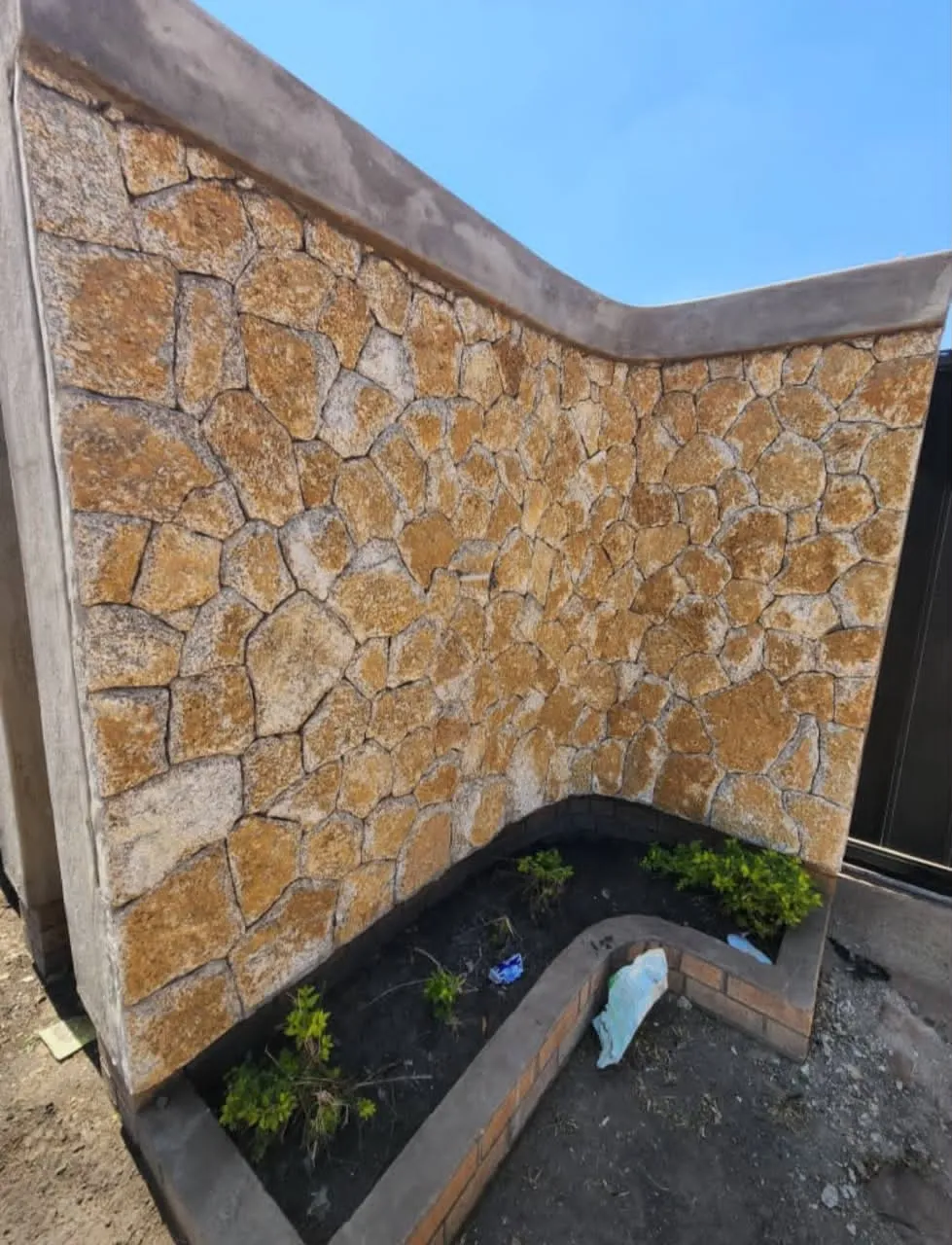 Boundary wall finished with natural stone cladding