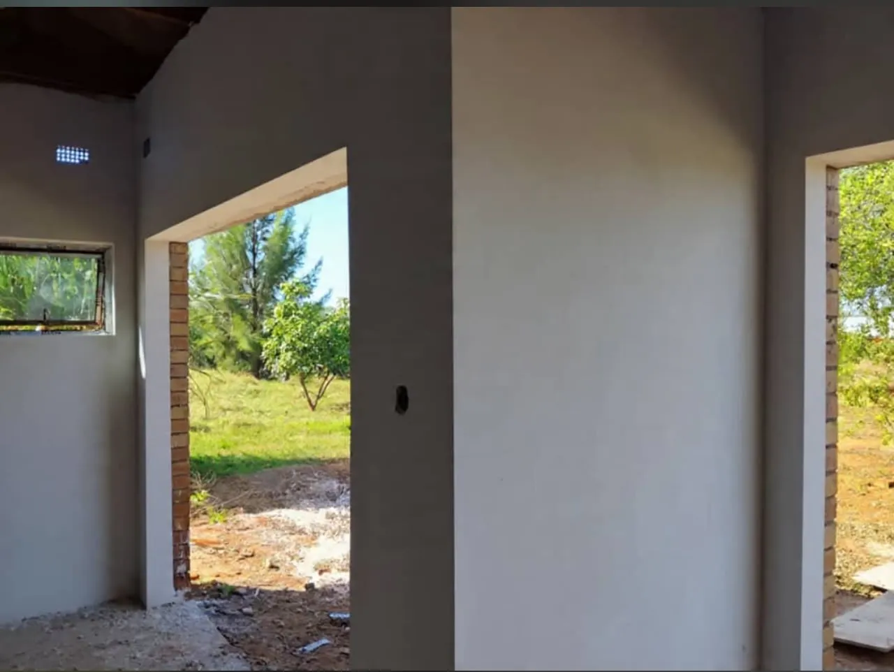Newly plastered interior walls with open doorways