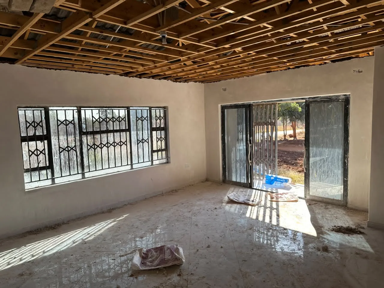 Bright interior with painted walls, tiled floor and ceiling frame above